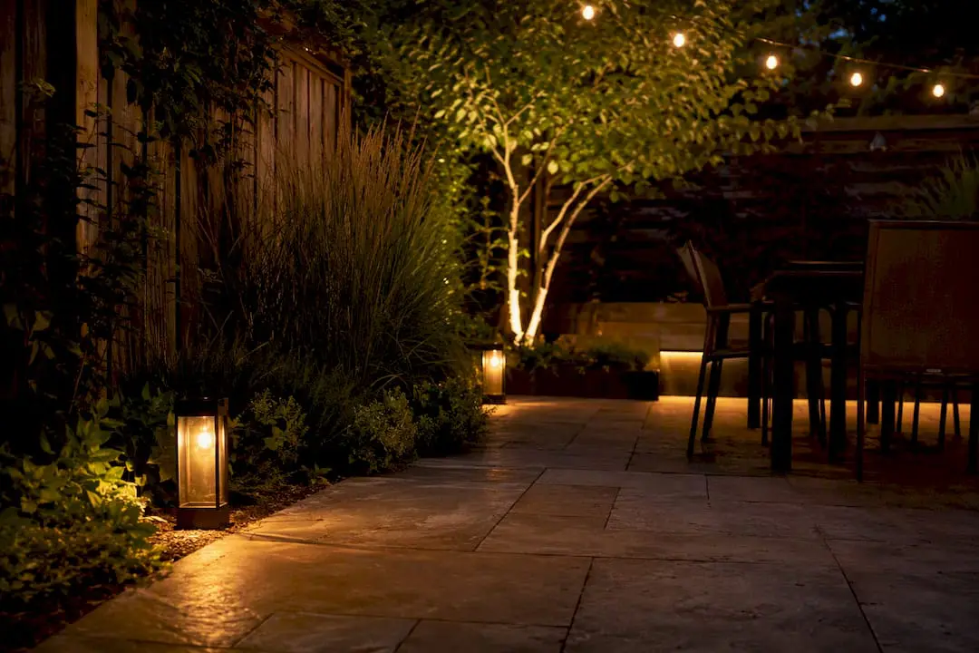Layered lighting and vertical plants on small patio
