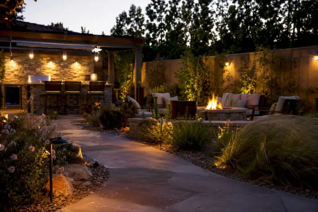 Modern backyard with outdoor kitchen and fire feature