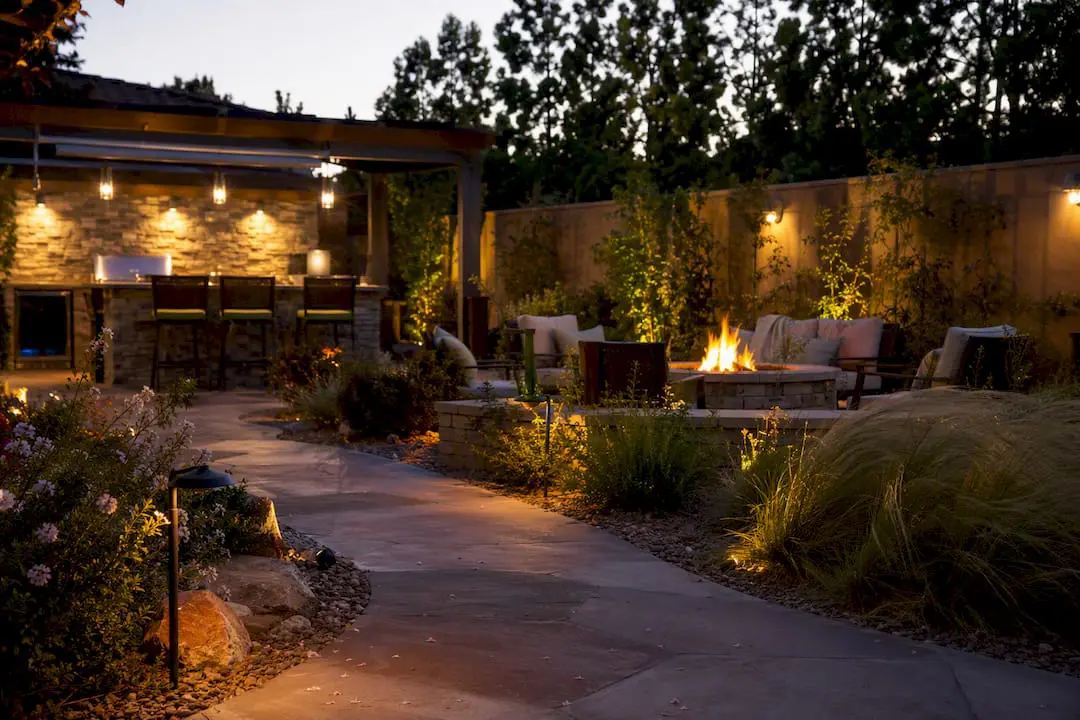 Modern backyard with outdoor kitchen and fire feature