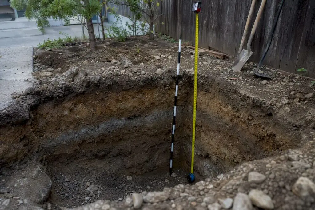 Excavated footing hole showing frost line depth