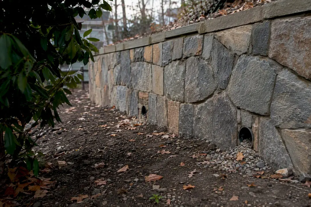 Retaining wall drainage detail in autumn setting