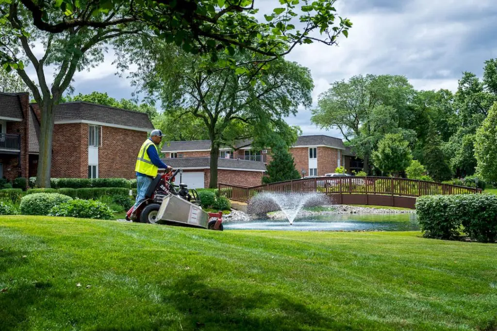 Crew mowing commercial turf area on site