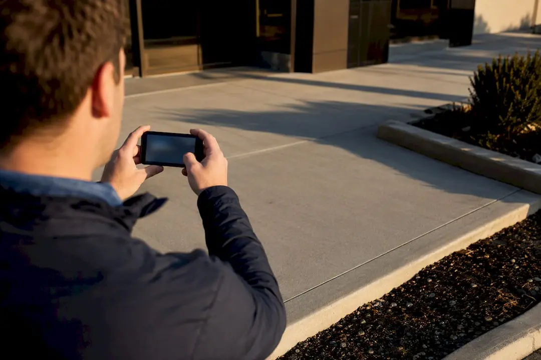 Property manager documenting bare commercial pavement