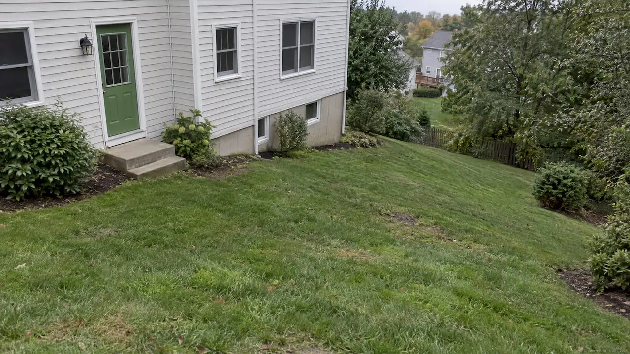 Sloping backyard beside a New Jersey home